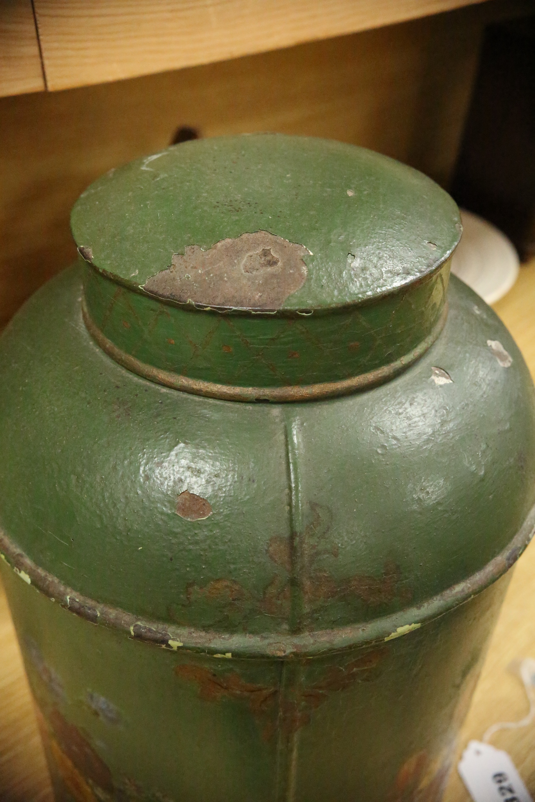 A green toleware floral decorated tea canister, 42cm high. Condition - poor, many chips to surface paint